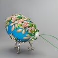 Load image into Gallery viewer, Golden Crown Easter Egg Beaded Ornament embellished with flowers, gold leaves, floral trim, and crystal beads. Top detail. (Sky Blue).
