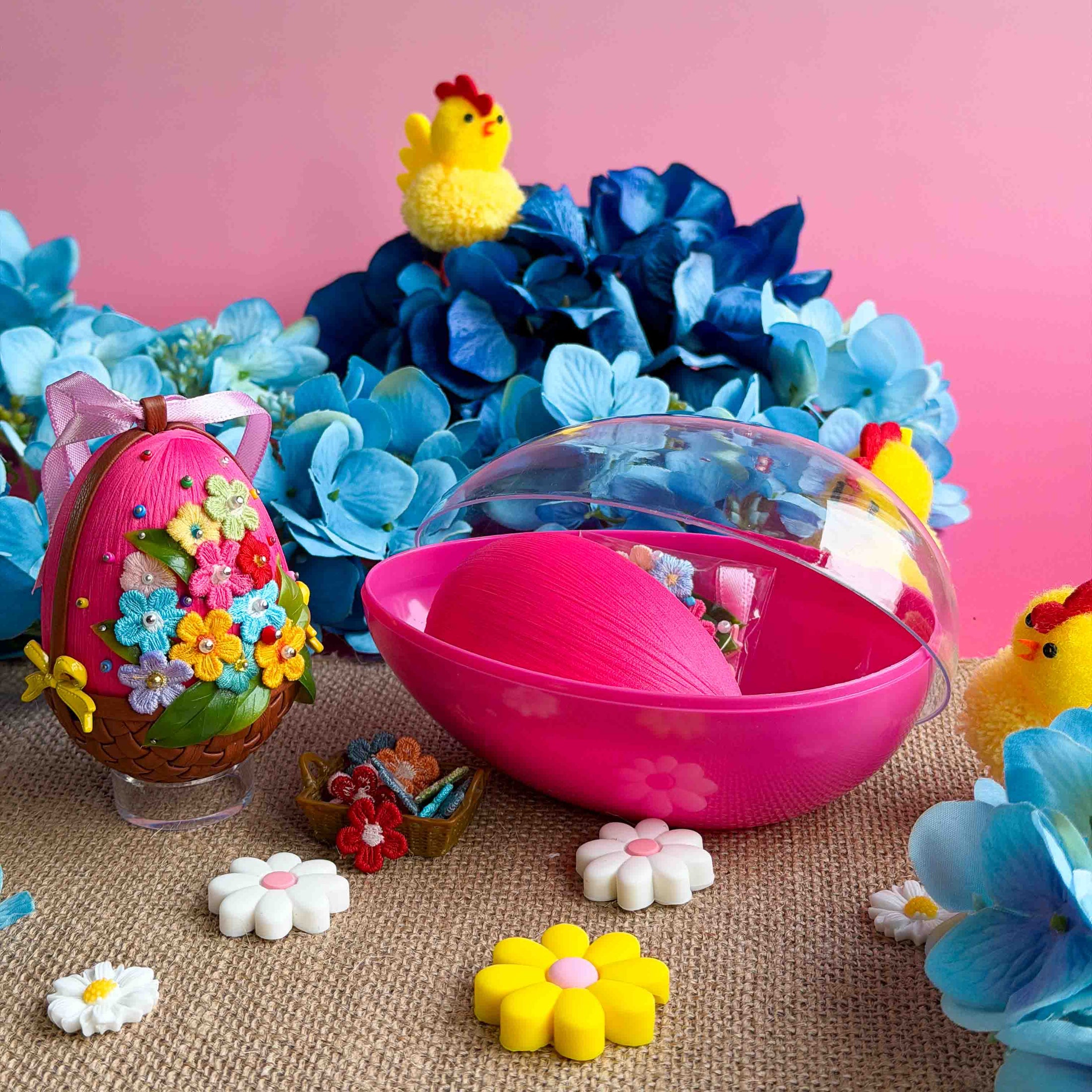 Pink Easter egg-shaped container with flowers and chicks on a pink background, push pin ornament kit. (Medium Pink)