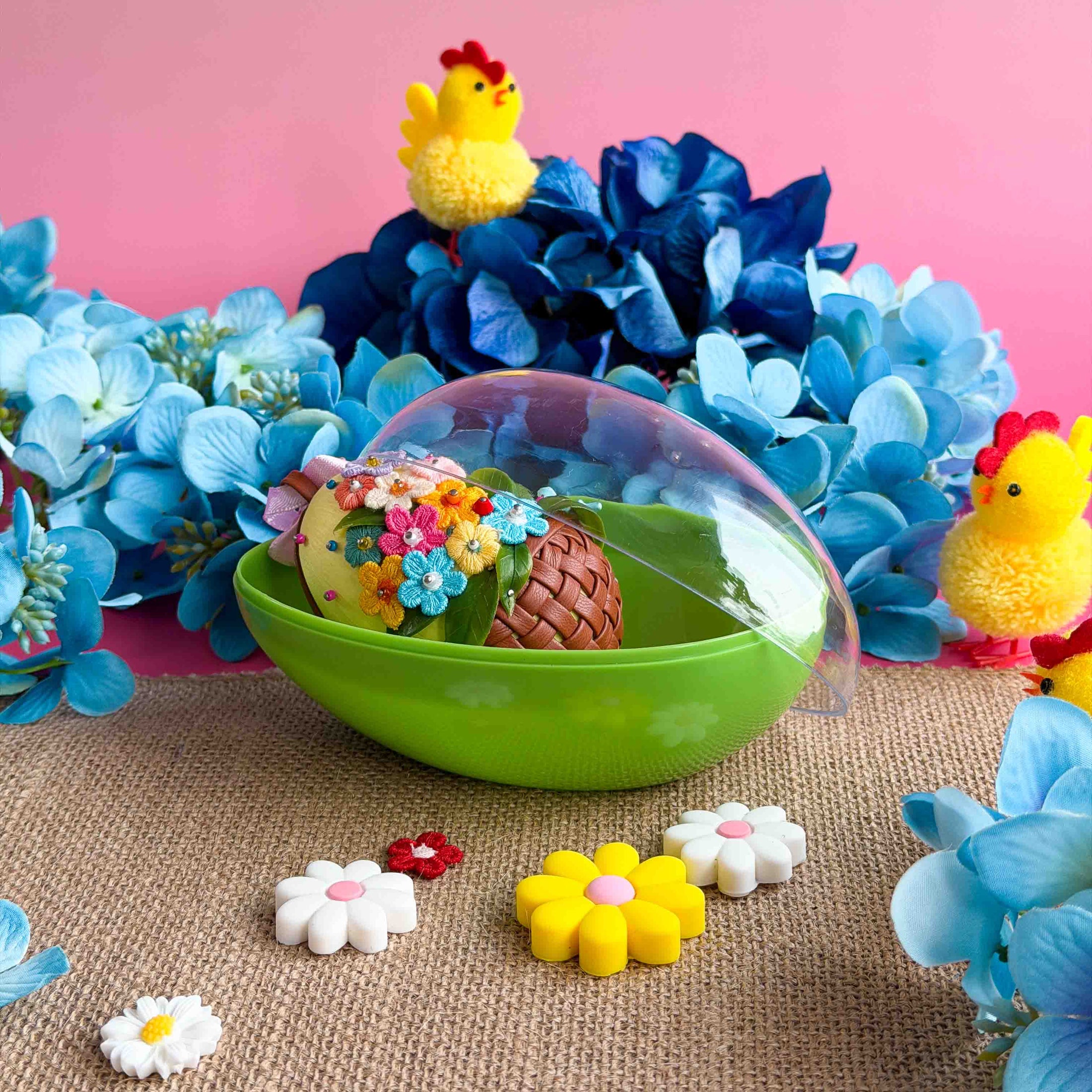 Colorful Easter-themed toys with flowers and a green bowl on a pink background. (Light Yellow)