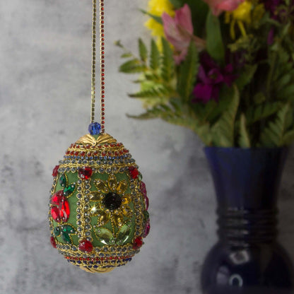Handmade Easter Egg Beaded Ornament embellished with flowers, leaves, gold floral trim, and crystal beads. Side. (Olive).