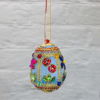 Handmade Easter Egg Beaded Ornament embellished with flowers, leaves, gold floral trim, and crystal beads. Side. (Sky Blue).