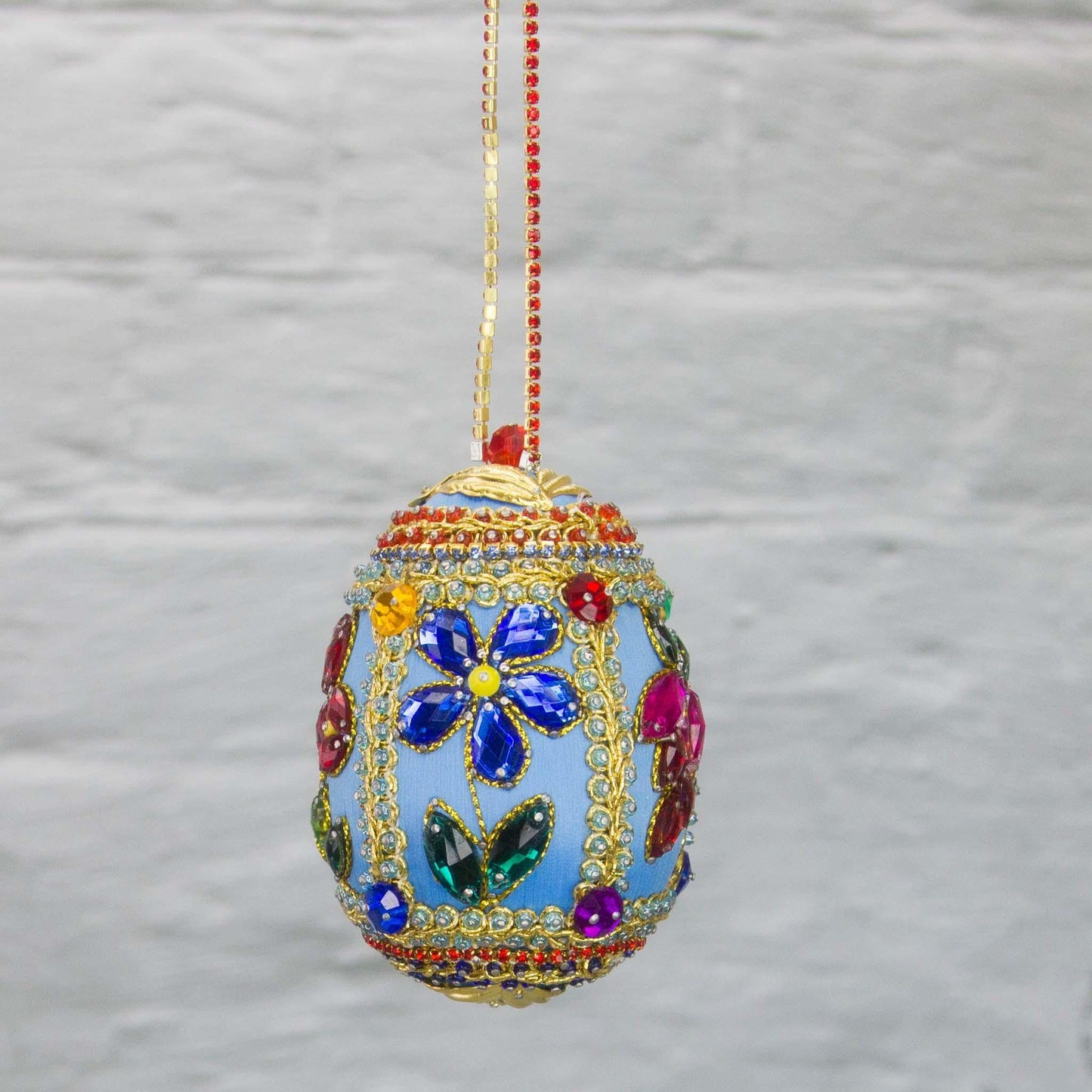 Handmade Easter Egg Beaded Ornament embellished with flowers, leaves, gold floral trim, and crystal beads. Side. (Sky Blue).