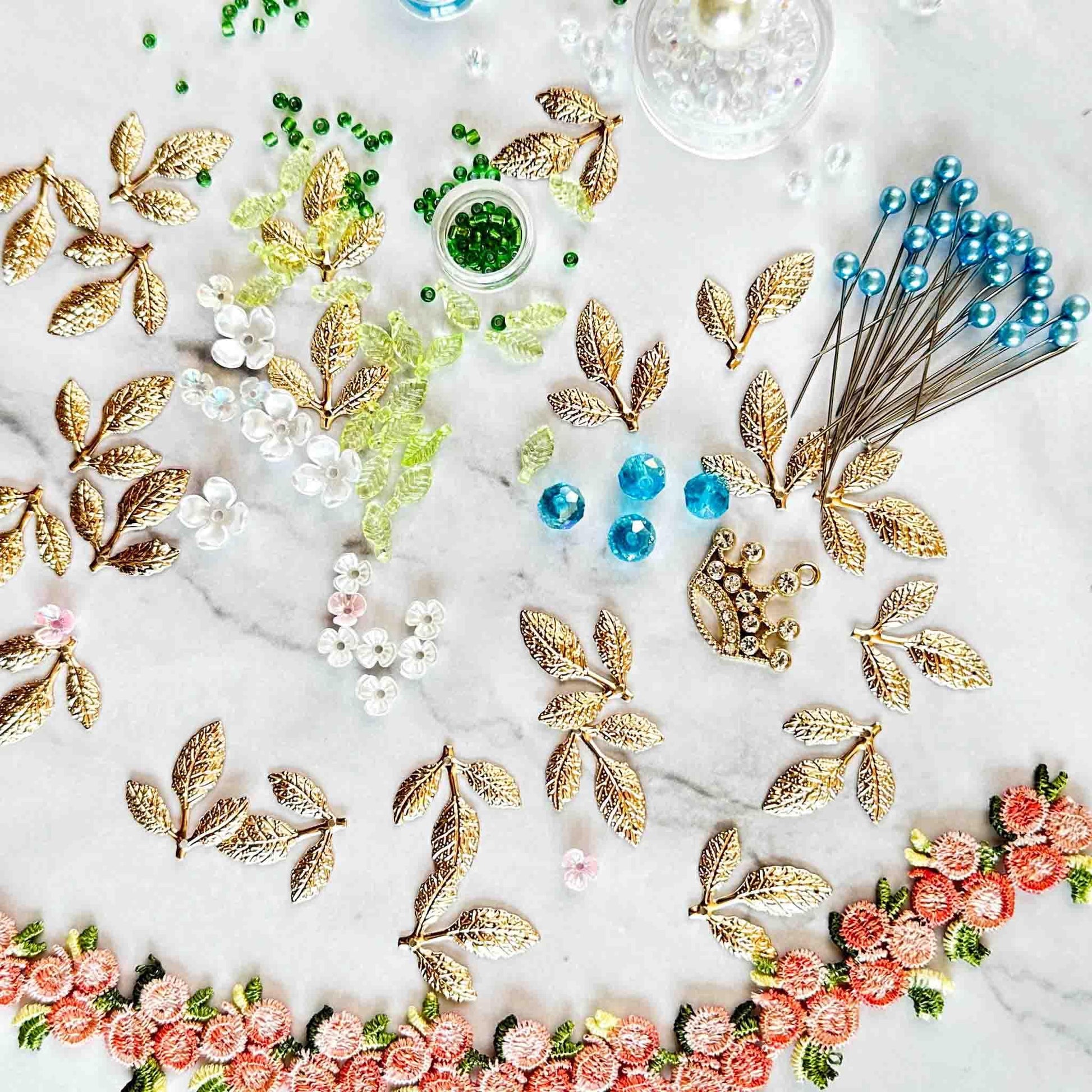 All of the materials needed to make Golden Crown Easter Egg Ornament: pins, flowers, gold leaves, floral trim, and crystal beads. (Light Yellow).