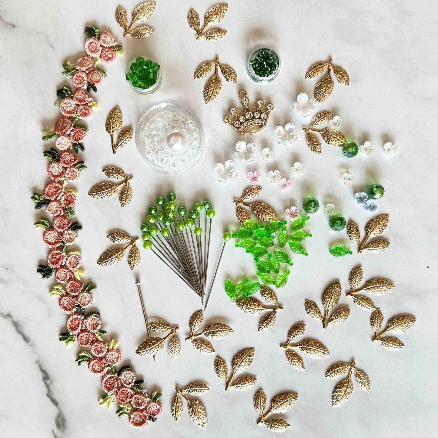 All of the materials needed to make Golden Crown Easter Egg Ornament: pins, flowers, gold leaves, floral trim, and crystal beads. (Sky Blue).