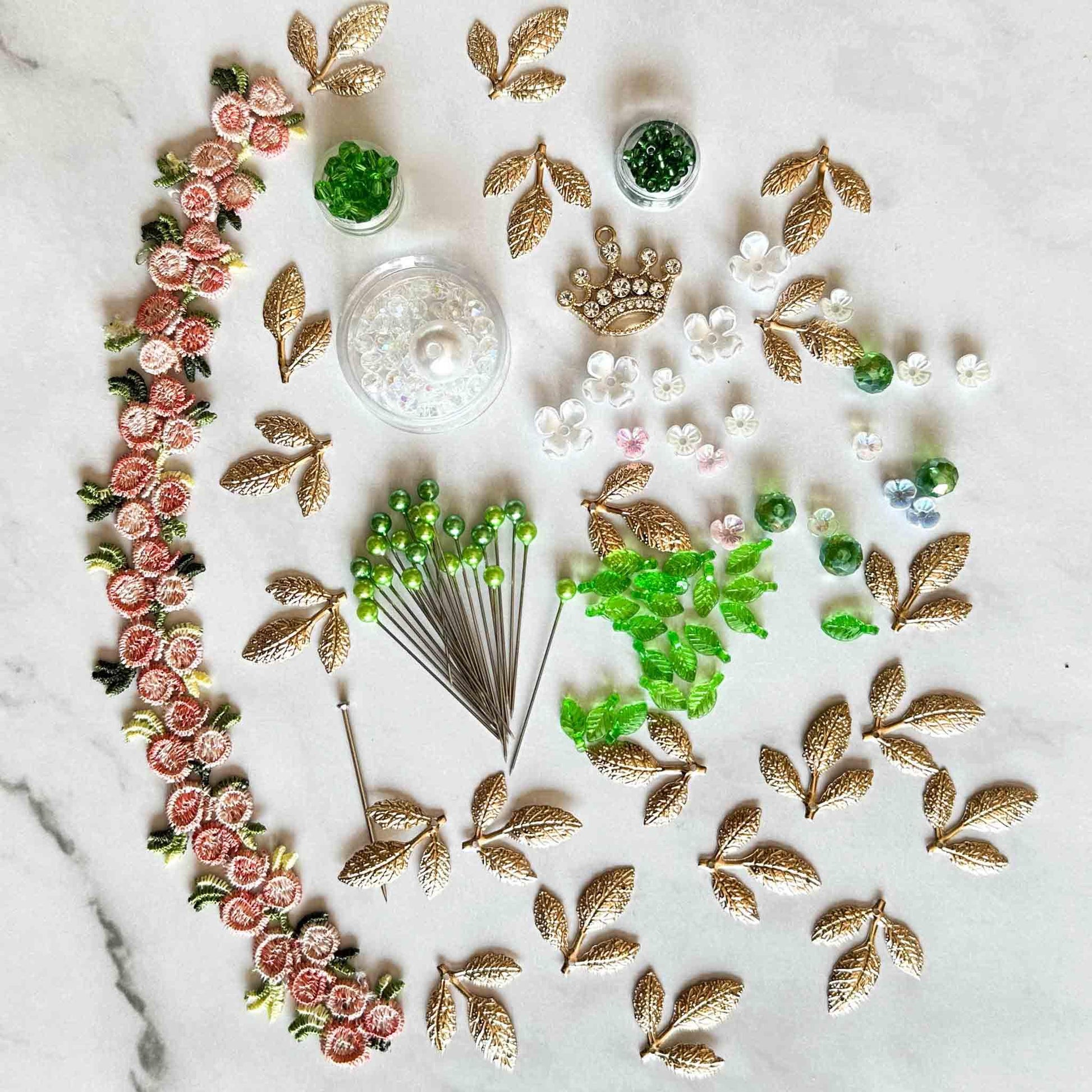 All of the materials needed to make Golden Crown Easter Egg Ornament: pins, flowers, gold leaves, floral trim, and crystal beads. (Sky Blue).