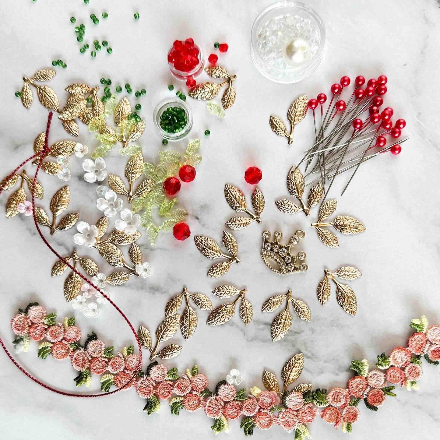 All of the materials needed to make Golden Crown Easter Egg Ornament: pins, flowers, gold leaves, floral trim, and crystal beads. (White).