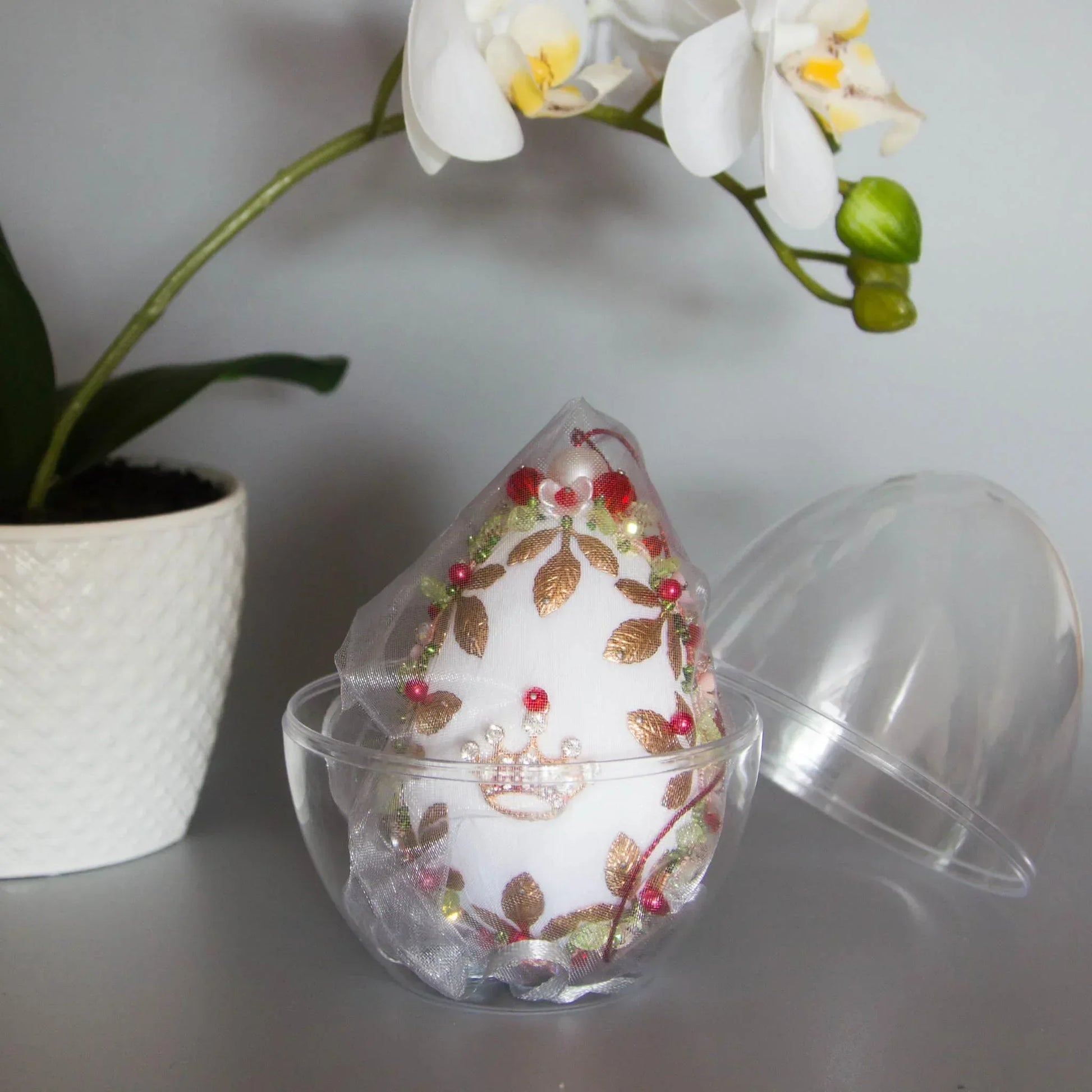 Handmade Easter Egg Ornament embellished with gold crown, beads, alloy leaf charms in an egg-shaped storage container. (White).