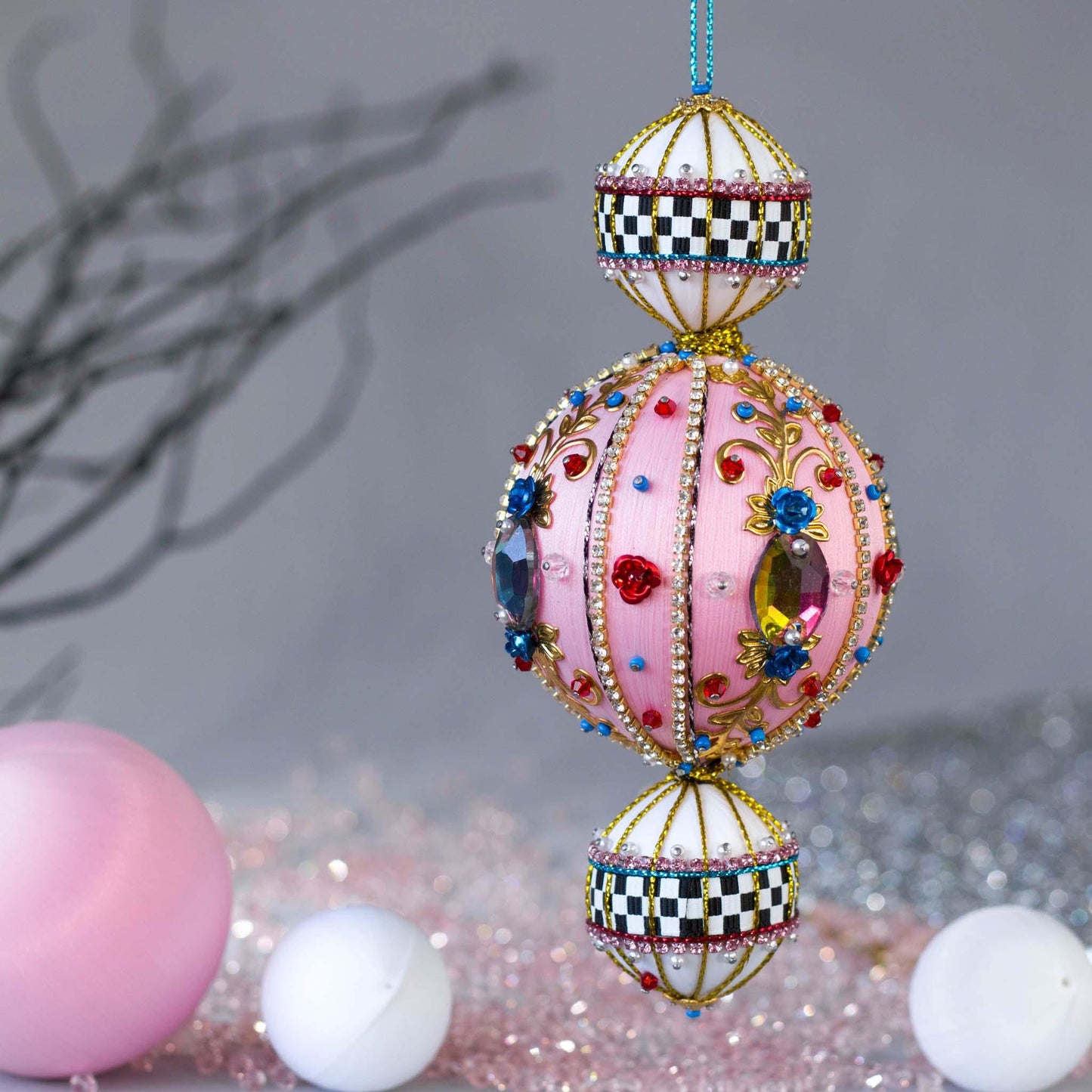 Handmade fun pink ornament with large glass rhinestones and a racetrack ribbon.