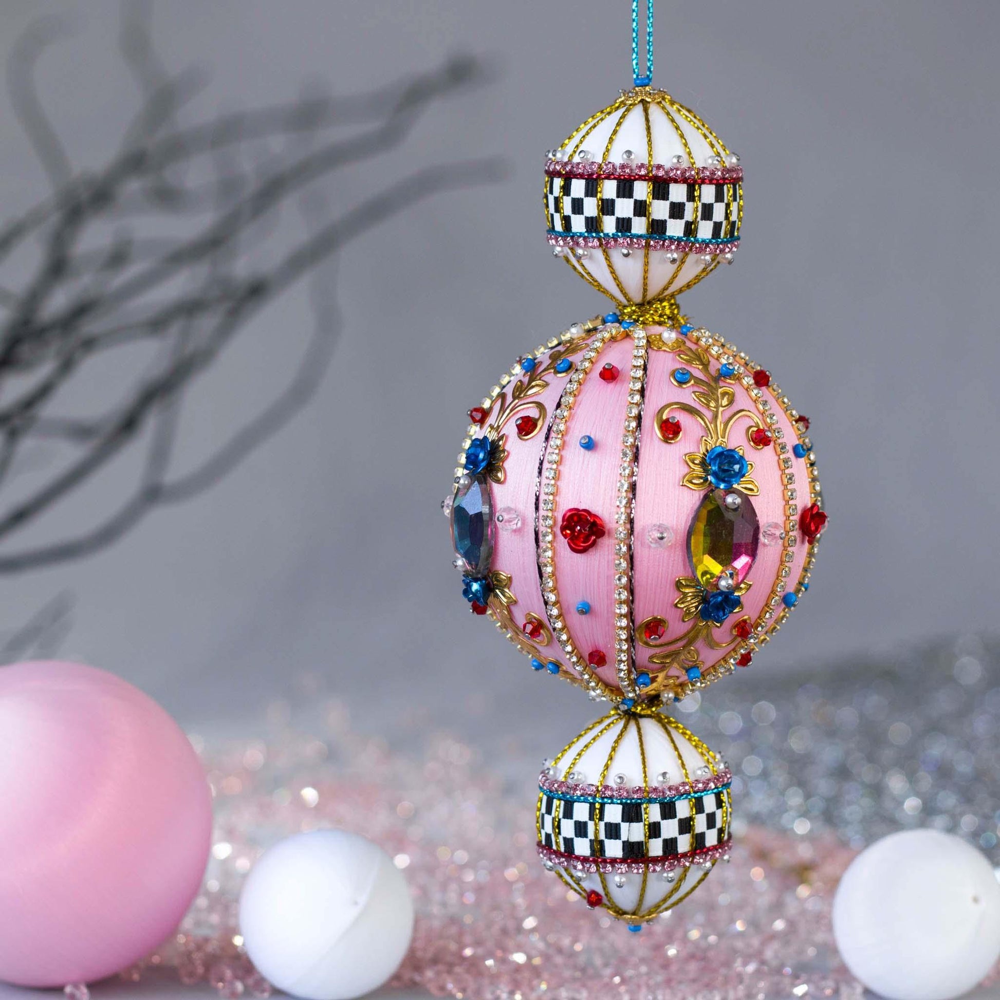 Handmade fun pink ornament with large glass rhinestones and a racetrack ribbon.