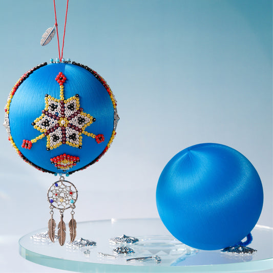 Bright blue 4" satin ball with a colorful star design and feather accents on a clear stand against a light blue background. (Sky Blue) 