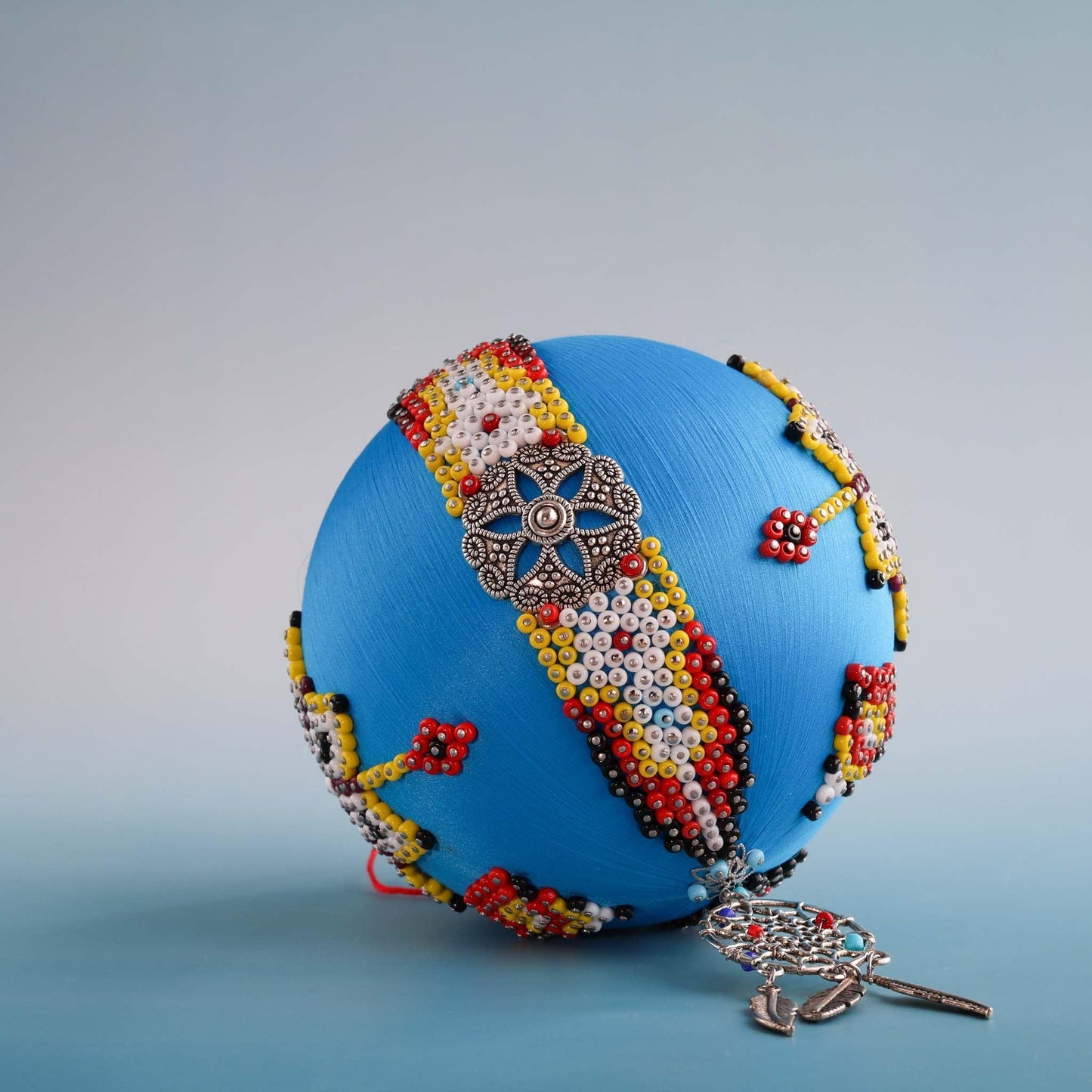 Close-up of beaded satin ornament with silver dream catcher charm.  (Sky Blue) 