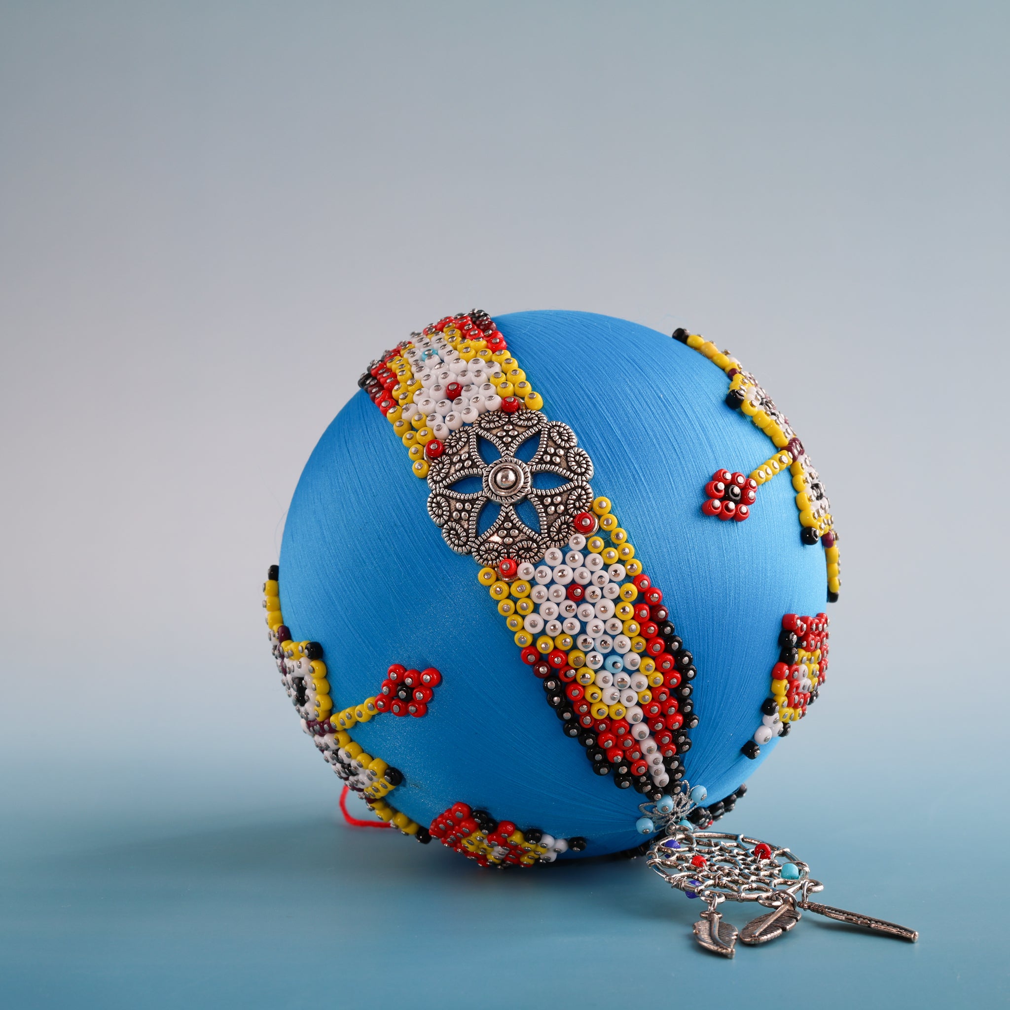 Close-up of beaded satin ornament with silver dream catcher charm.  (Sky Blue) 