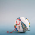 Load image into Gallery viewer, Christmas satin ornament inspired by indigenous beadwork and patterns on a blue background with cute feather charm.  (White)
