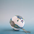 Load image into Gallery viewer, Christmas satin ornament inspired by indigenous beadwork and patterns on a blue background.  (White)
