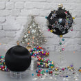 Load image into Gallery viewer, Jingle Bells Satin Ornament -Black DIY Christmas push pin kit, featuring large glass beads, sparkling silver trim, sequins, and alloy snowflakes, set against a white brick backdrop.
