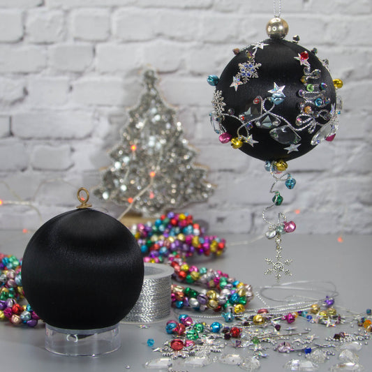 Jingle Bells Satin Ornament -Black DIY Christmas push pin kit, featuring large glass beads, sparkling silver trim, sequins, and alloy snowflakes, set against a white brick backdrop.