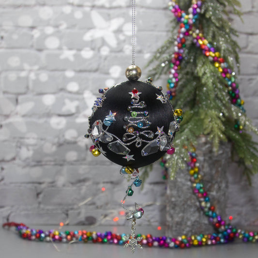 Jingle Bells Satin Ornament -Handmade Black Christmas Beaded Decoration, featuring large glass beads, sparkling silver trim, sequins, and alloy snowflakes, set against a small evergreen tree.