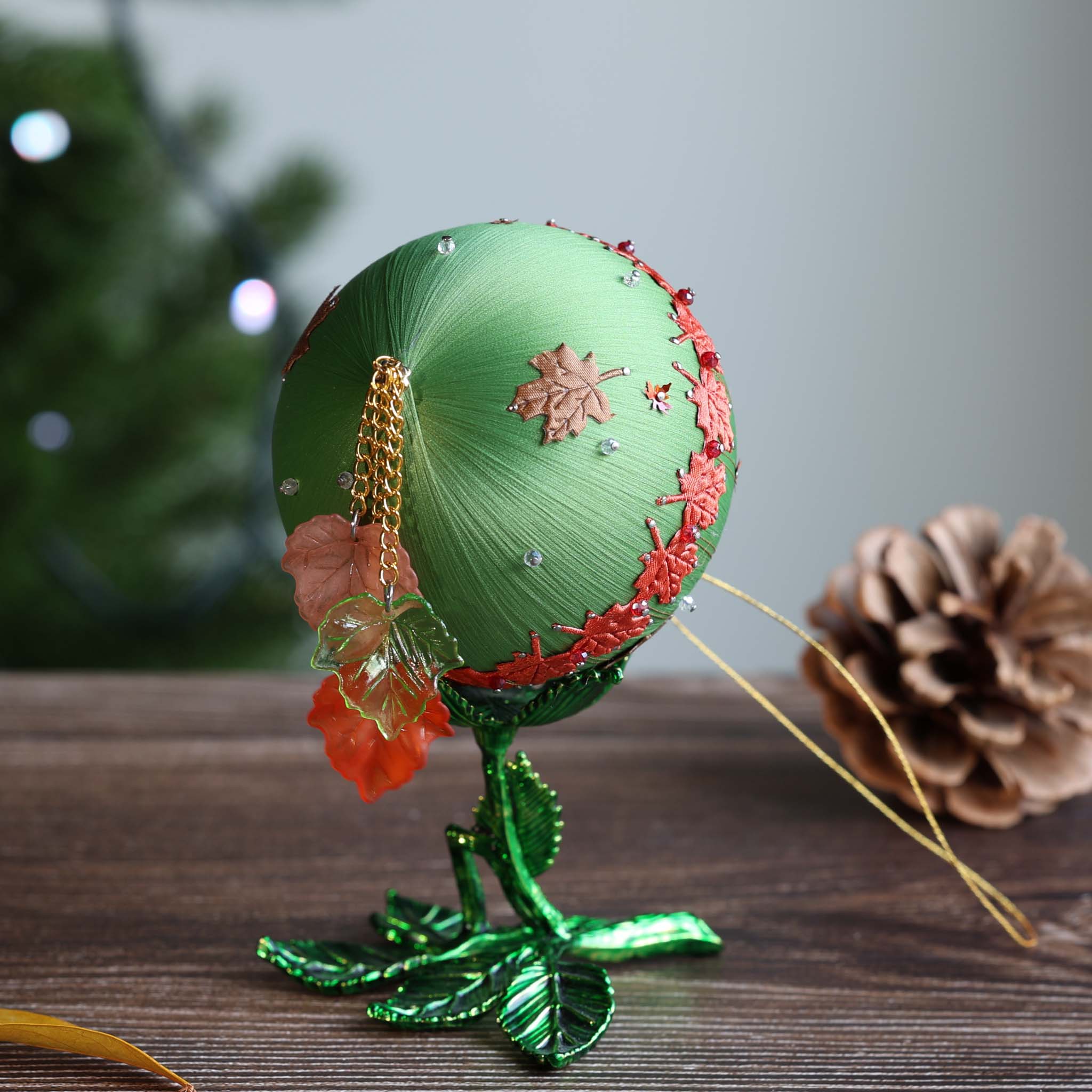 Detail of the tassel on the bottom of a green ornament. (Olive)