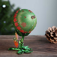 Load image into Gallery viewer, Christmas ball ornament wrapped in satin threads and embelished with red floral trim on a wooden surface. (Olive)

