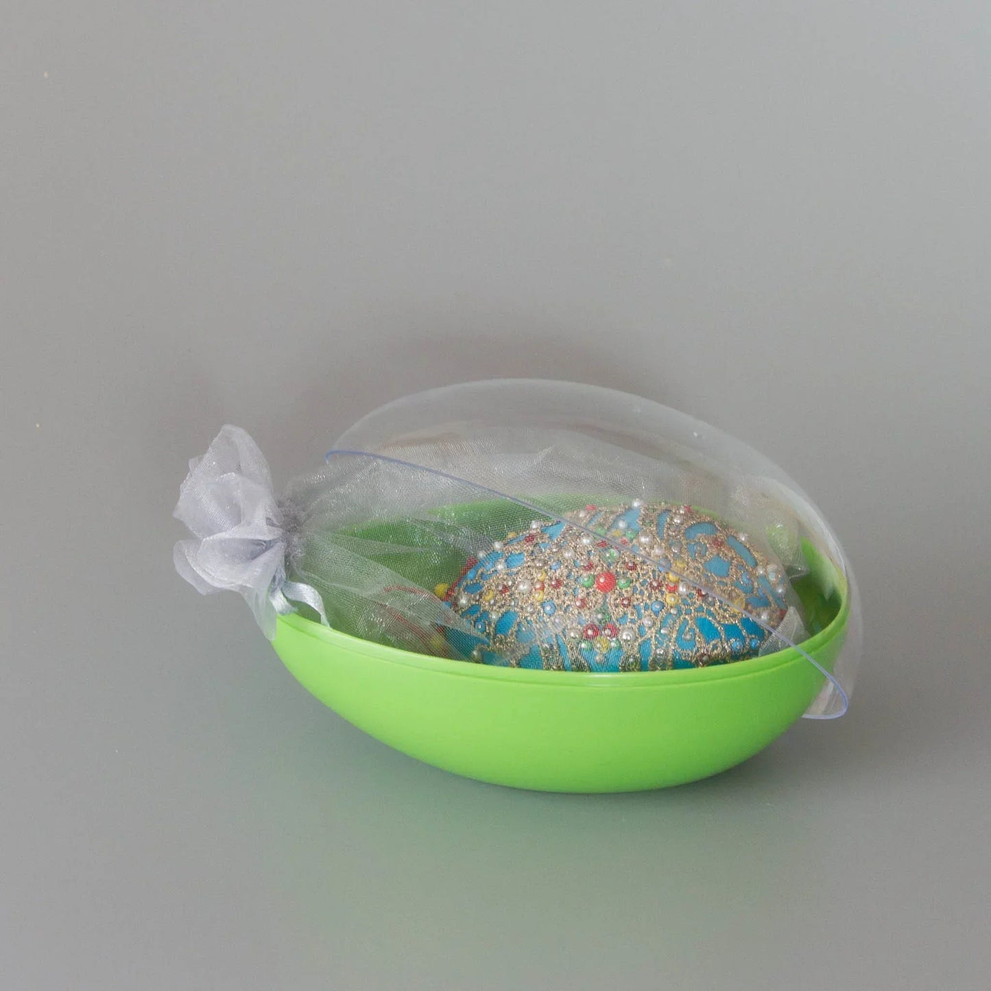 Handmade satin ornament Misbah in organza bag packed in an egg-shaped container with a clear lid. (Sky Blue)