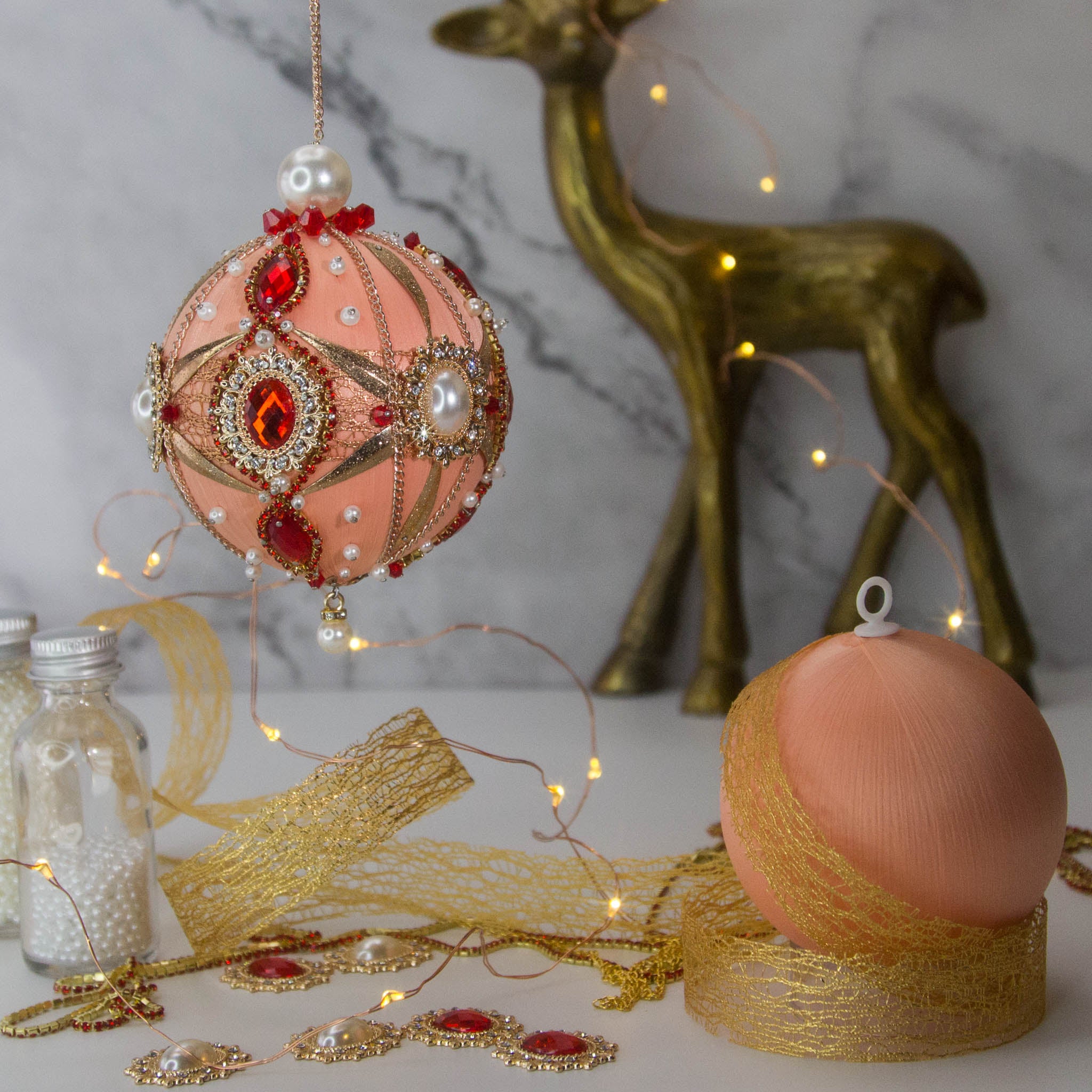 Phoenix Christmas Beaded Push Pin Satin Ornament Kit features large cameos with red rhinestones, gold alloy accents, and gold chain. (Coral)