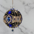 Load image into Gallery viewer, Phoenix Christmas Beaded Handmade Satin Ornament features large cameos with indigo blue rhinestones, gold alloy accents, and rose old chain. (Black)
