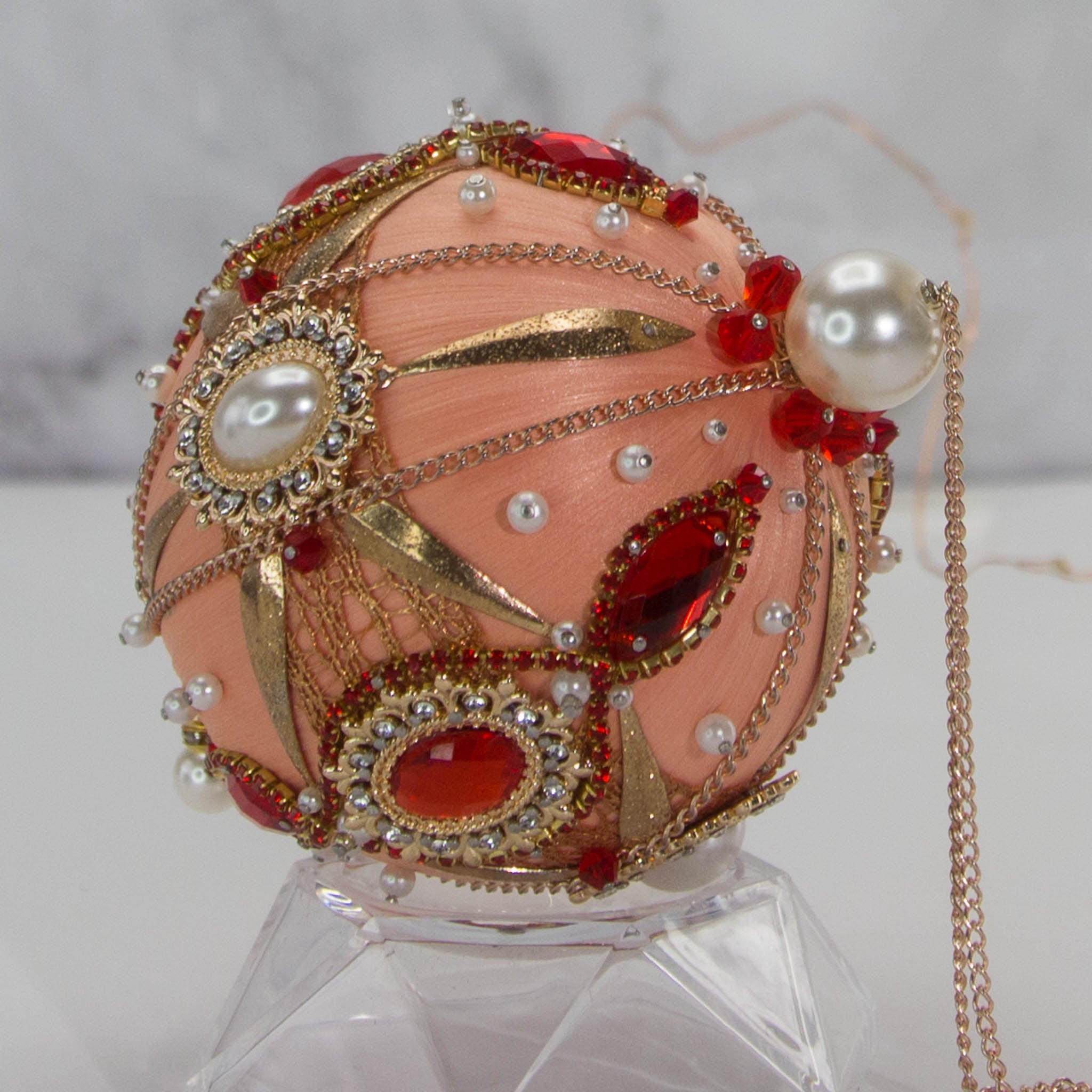 Phoenix Christmas Beaded Handmade Satin Ornament features large cameos with bright red rhinestones, beautifully contrasted against the peachy satin ornament. (Coral)