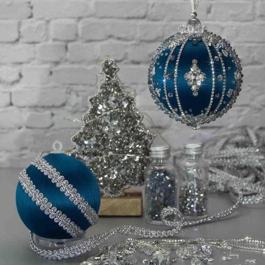 Polar Night Satin Ornament -Elegant DIY Christmas push pin kit, featuring blue satin ball, sparkling silver beads, sequins, and rhinestone accents, perfect for holiday crafting, set against a white brick backdrop.
