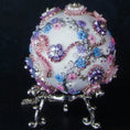 Load image into Gallery viewer, Princess Satin Egg Ornament -a close-up of an elegant Handmade Easter decoration, sitting on a display stand, adorned with sparkling beads, trims, rhinestones, and daisies, set against a dark background.
