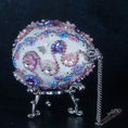 Load image into Gallery viewer, Princess Satin Egg Ornament -a close-up of an elegant Handmade Easter decoration, crown detail, adorned with sparkling beads, trims, rhinestones, and daisies, set against a dark background.
