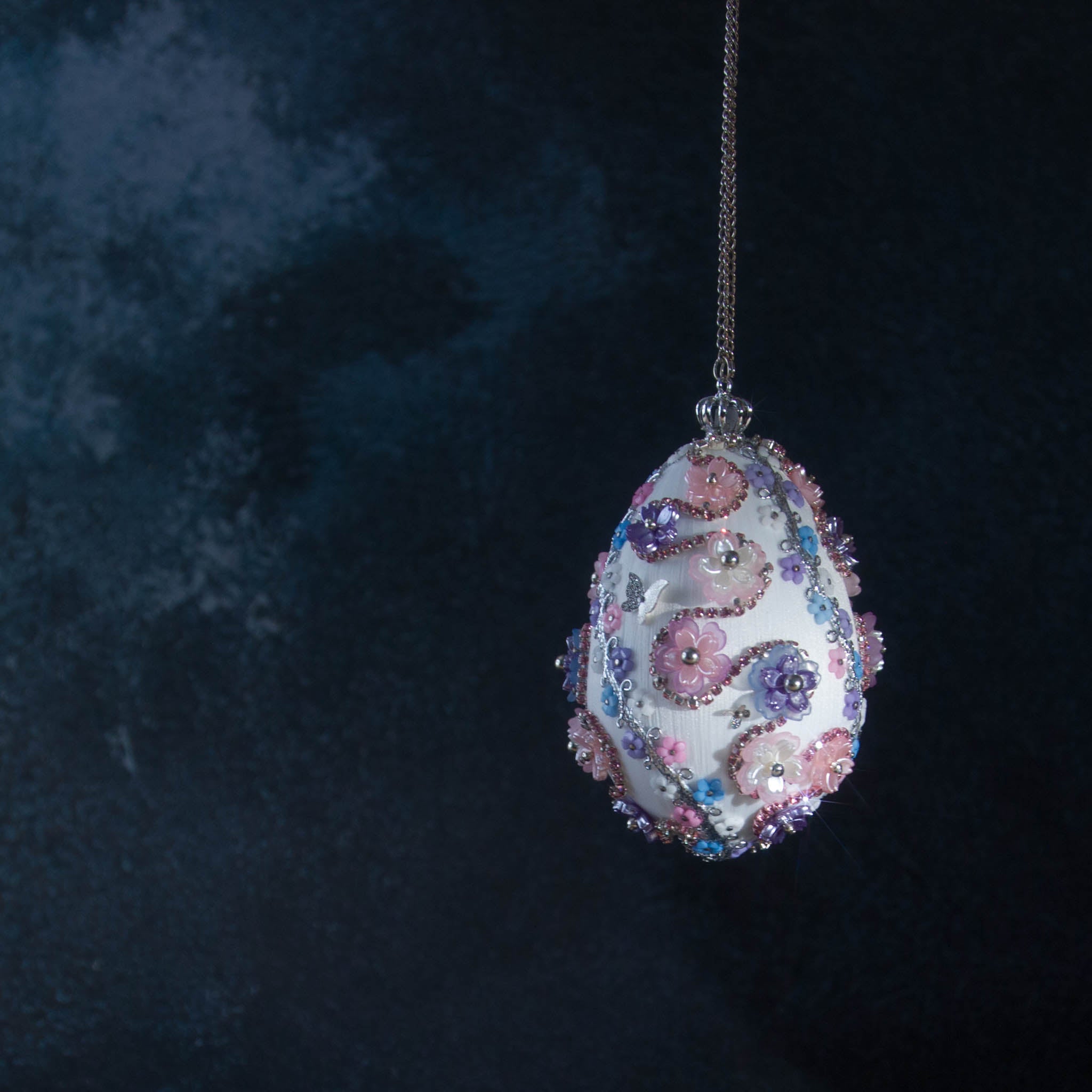 Princess Satin Egg Ornament -Elegant Handmade Easter decoration, adorned with sparkling beads, trims, rhinestones, and daisies, set against a dark background.