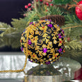 Load image into Gallery viewer, Quam Handmade Christmas Satin Ornament in Black with gold metal embellishments and purple rhinestones in front of evergreen branch. (Black)
