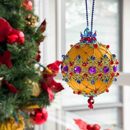 Christmas ornament with colorful gemstones hanging on a tree.