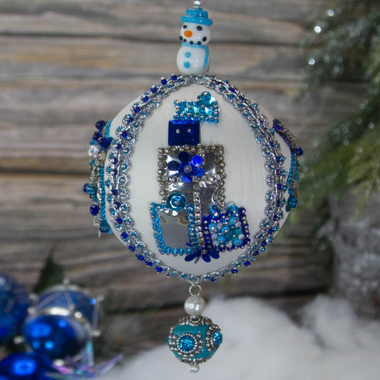 Handmade Beaded Ornament from Whim5seaons with an adorable ceramic snowman in front of a Christmas tree.