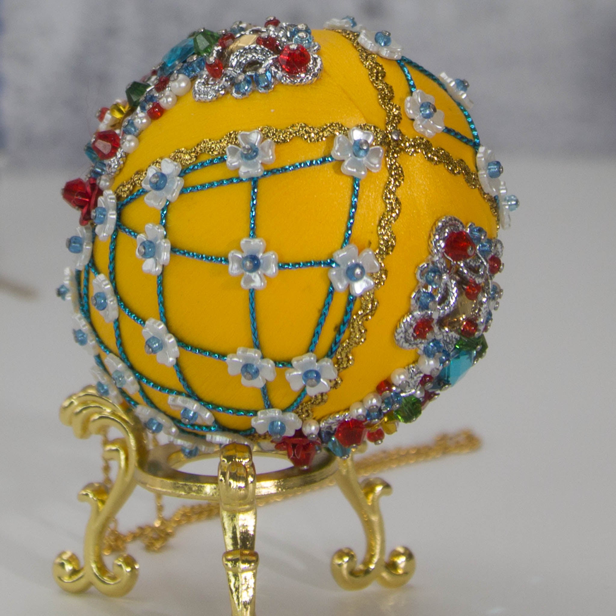 Easter or Christmas Beaded Ornament embellished with crystals, beads, and metallic trim . Bottom detail. (Dark Orange).