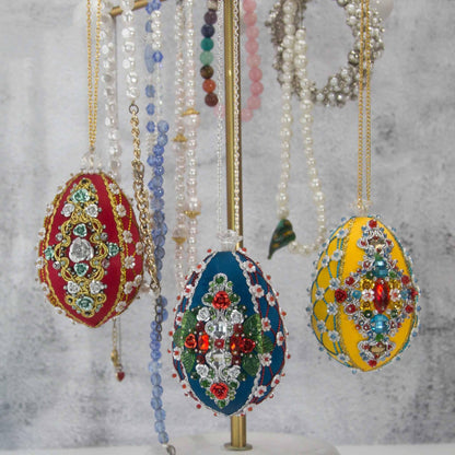 Collection of handmade satin ornaments embellished with crystals, beads, and metallic trim 