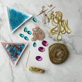 Load image into Gallery viewer, Materials to make Christmas Beaded Ornament by pinning glass rhinestones, gold braided trim, and crystal beads. to a satin ball. (Medium Purple)
