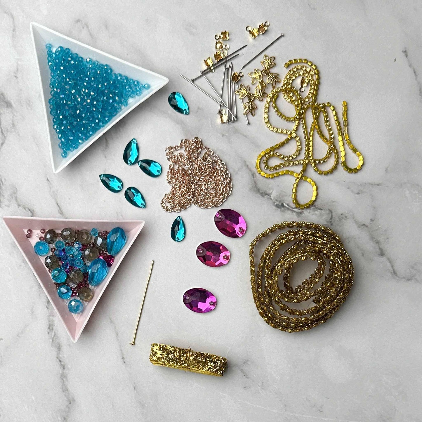 Materials to make Christmas Beaded Ornament by pinning glass rhinestones, gold braided trim, and crystal beads. to a satin ball. (Medium Purple)
