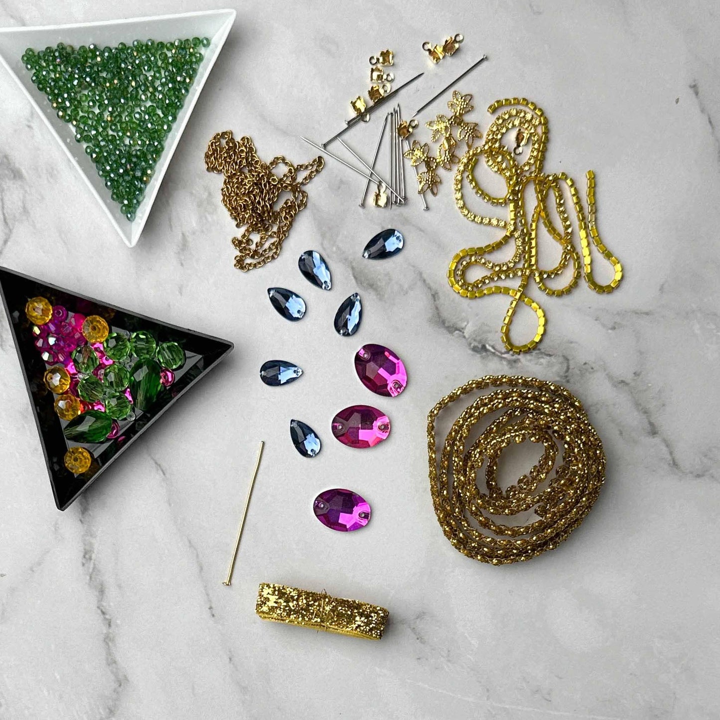 Materials to make Christmas Beaded Ornament by pinning glass rhinestones, gold braided trim, and crystal beads. to a satin ball. (Olive).