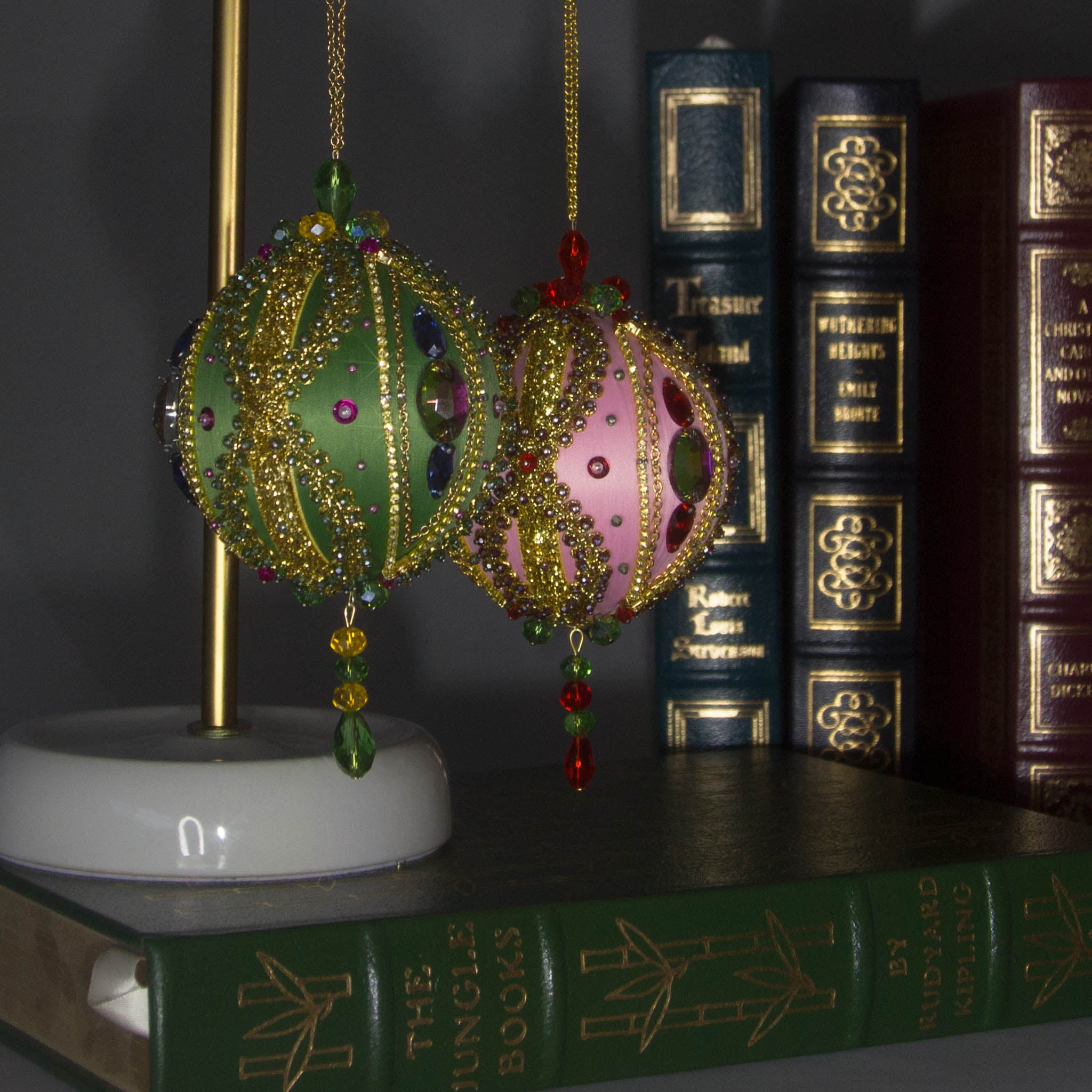 Collection of handmade Beaded Christmas Ornaments Uliger embellished with gold trim, color-shifting rhinestones, and sequins.