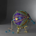 Load image into Gallery viewer, Christmas Beaded Ornament Kit Ball embellished with glass rhinestones, gold braided trim, and crystal beads. Bottom detail. (Indigo).
