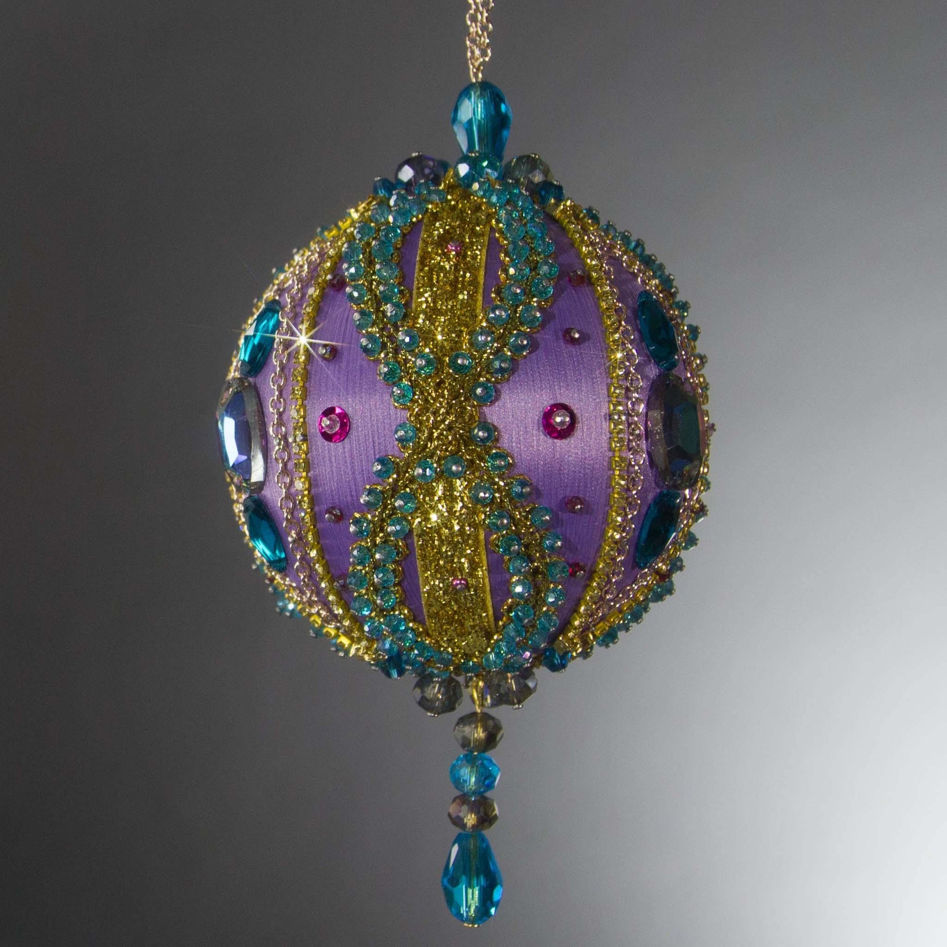 Christmas Beaded Ornament Kit Ball embellished with glass rhinestones, gold braided trim, and crystal beads. Side View. (Medium Purple).