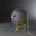 Load image into Gallery viewer, Christmas Beaded Ornament Kit Ball embellished with glass rhinestones, gold braided trim, and crystal beads. Top detail. (Medium Purple).
