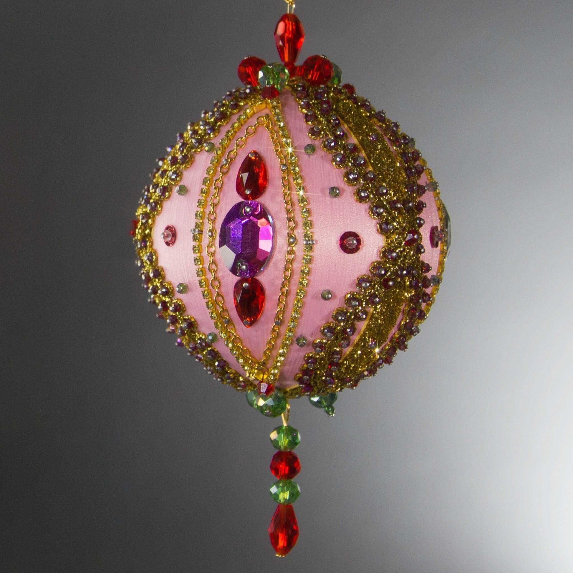 Christmas Beaded Ornament Kit Ball embellished with glass rhinestones, gold braided trim, and crystal beads. Front. (Light Pink).
