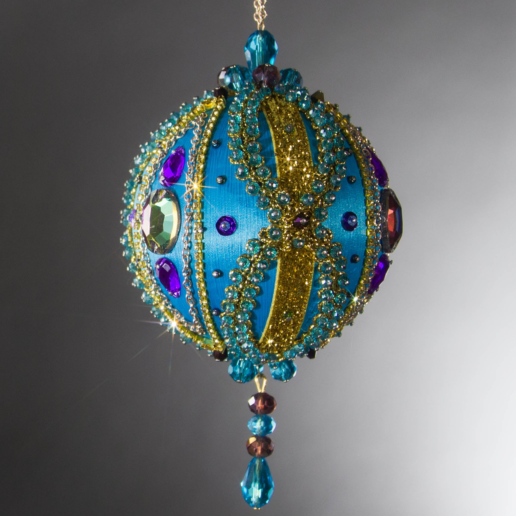 Christmas Beaded Ornament Kit Ball embellished with glass rhinestones, gold braided trim, and crystal beads. Front. (Sky Blue).