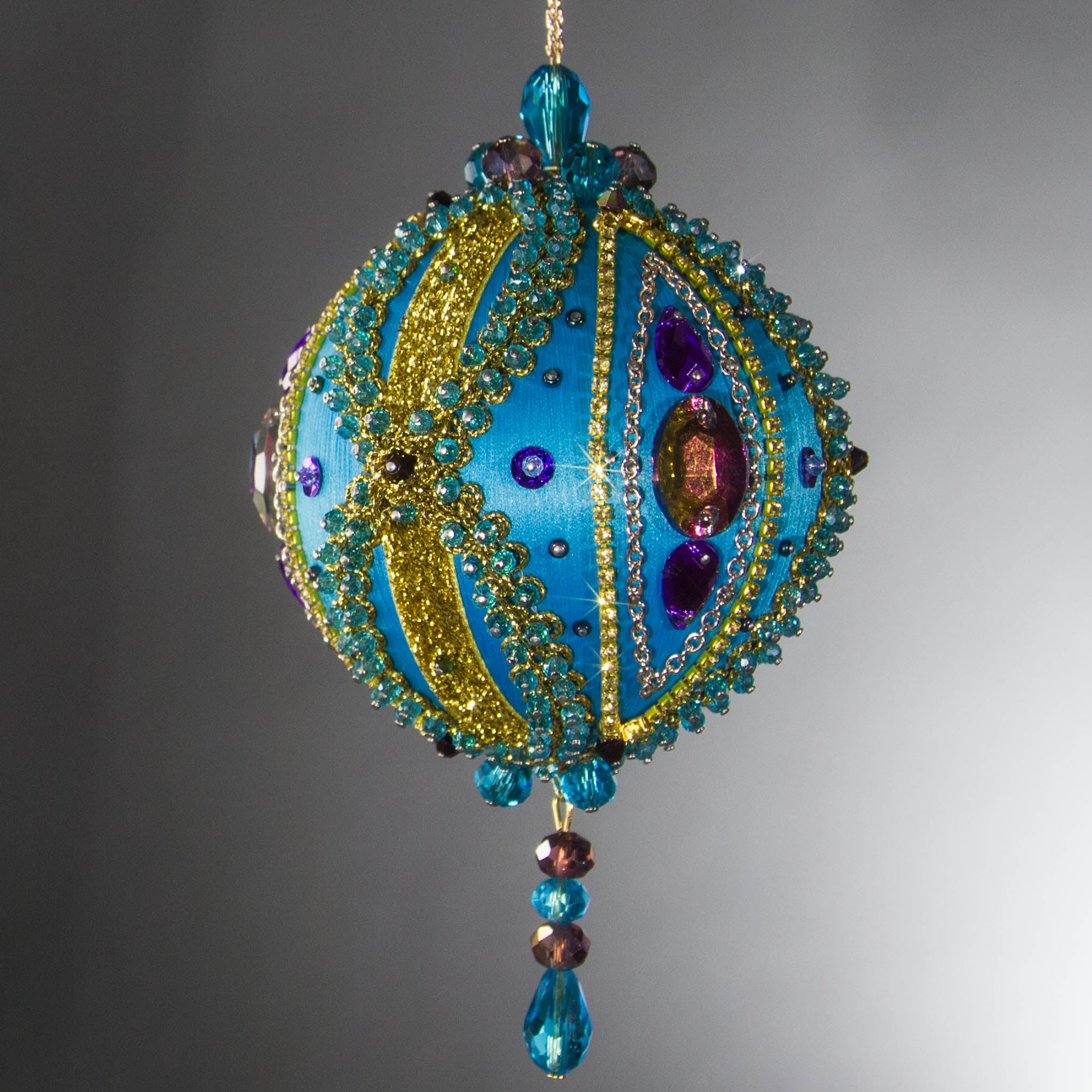 Christmas Beaded Ornament Kit Ball embellished with glass rhinestones, gold braided trim, and crystal beads. Side view. (Sky Blue).