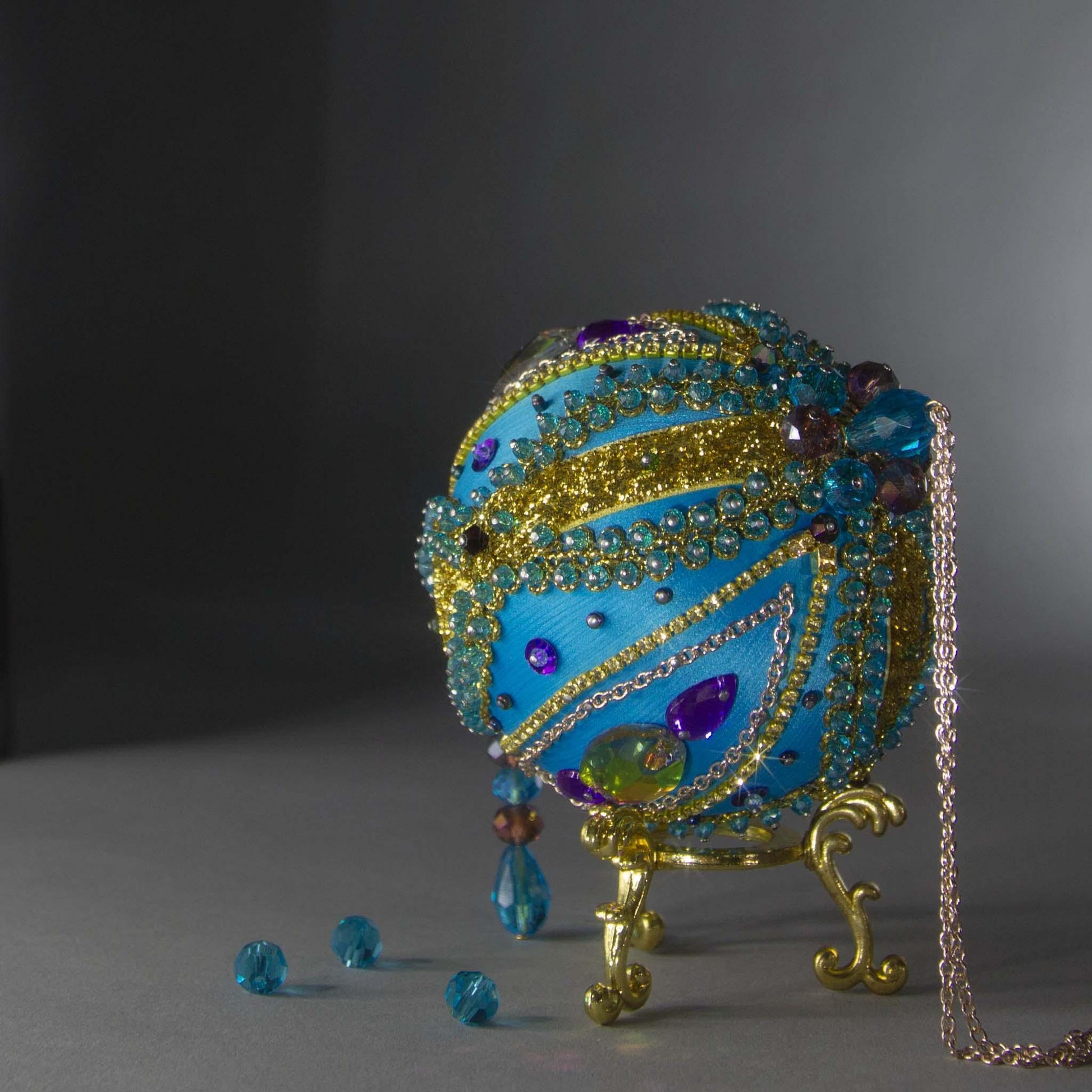 Christmas Beaded Ornament Kit Ball embellished with glass rhinestones, gold braided trim, and crystal beads. Top detail. (Sky Blue).