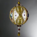 Load image into Gallery viewer, Handmade Satin Ornament by Whim5seasons embellished with glass rhinestones, gold braided trim, and crystal beads. Side view. (White).
