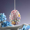 Load image into Gallery viewer, Decorative Easter egg with floral patterns hanging above blue flowers on a gradient background.  (Pale Violet Red)
