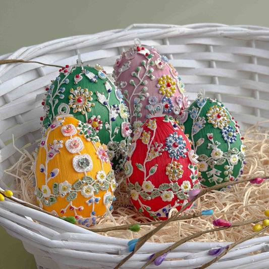 Decorative Easter eggs with floral patterns in a white basket.